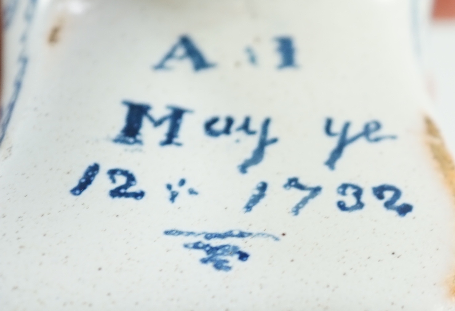 A documentary English delftware blue and white model of a shoe, dated 1732, 16cm long, damage